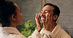 Skincare, couple and love in bathroom, help and smile with facial treatment for hydration. Man, woman and apply moisturizer for dermatology with beauty care, wellness or collagen with support at home