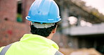 Back, engineer and inspection at construction site with hard hat, safety and assessment for architecture. Man, helmet and evaluation outdoor for renovation, quality assurance and building development