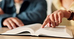 Hands, couple and reading in home with bible, study scripture and morning prayer for guidance. People, relax and faith at house with holy book, religious practice and knowledge for spiritual healing
