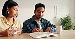 Couple, rest and reading in home with bible, study scripture and morning prayer for guidance. People, listen and coffee at house with holy book, religious practice and knowledge for spiritual healing