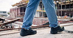Man, legs and walk on construction site with inspection, civil engineering project and infrastructure. Person, work boots and engineer outdoor with property development, check building or renovation.