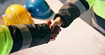 Handshake, blueprint and construction workers on site with deal, partnership or maintenance agreement. Floor plan, people and top view of contractor shaking hands with civil engineer for building.