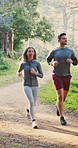 Fitness, couple and running in woods with smile, healthy relationship or cardio workout for wellness. Happy, people dating and runner in nature with exercise, endurance and training together outdoor.