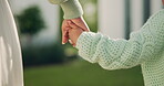 Care, mother and child holding hands in backyard for outdoor safety, parenting and protection. Love, mom and kid with bonding together at house for trust, development support and security in garden