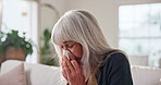 Tissue, sneeze or old woman blowing nose in home with influenza, health problem and virus symptoms. Sick, senior person and allergies in living room with toilet paper, hayfever and sinus infection.