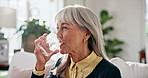 Senior, woman or drinking water in living room with glass, wellness and natural detox for gut health. Thirsty, old person and liquid beverage in home with hydration, nutrients and digestion benefits.