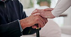 Caregiver, comfort and holding hands with senior person, empathy and health services in nursing home. Nurse, help and support for elderly patient with walking stick, kindness and healthcare in house