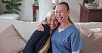 Support, hug and nurse with old woman on sofa in home for elderly care, retirement and bonding. Embrace, consulting and medical advice with senior person and caregiver in house for wellness and smile