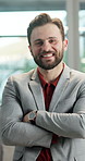 Crossed arms, professional and face of businessman in office with confidence for finance career. Smile, corporate and portrait of male financial manager with pride for company about us in workplace.