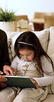 Parent, child and tablet with game on sofa for problem solving, development or bonding activity. Learning, family or kid with tech in home for playing online puzzle, digital literacy or relationship