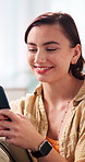 Laugh, phone and woman on sofa for social media, online chatting and message for contact on weekend. Home, happy and person on mobile app for connection, networking and notification for communication