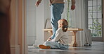 Legs, dad and child with attachment in home for separation anxiety, dependence or sad for leaving. Clingy behavior, father and dragging girl for emotional connection, attention and struggle to walk