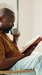 Coffee, reading book and relax with black man on chair in home living room for literature hobby. Break, drink and story with mature person in apartment for fantasy or fiction novel on weekend morning