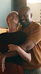 Couple, hug and dancing in kitchen, laughing and bonding with partner on anniversary or special day. Mature people, celebration and rhythm with spouse, romance and relationship commitment in home