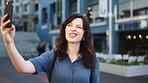 Woman, selfie and laugh with travel in city, funny face and wink for post on web with memory on solo trip. Person, happy and photography with profile picture, mobile app or social media in urban town