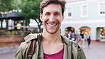 Laugh, city and face of man for tourism, commute and travel for holiday abroad or vacation. Happy, outdoor and portrait of person with smile for tourist experience, trip and explore town on weekend
