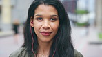 Travel, face and woman with earphones in city, happy or streaming music with subscription on holiday. Outdoor, portrait and person with smile, traveler and listening to audio with tech in Colombia