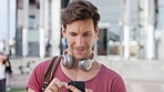 Man, student and phone with texting in city at campus with smile, check notification or online dating. Gen z person, happy and scroll with mobile app, contact and post on social media at university