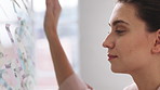 Woman, glass wall and sticky note at startup with project management, planning or review at office. Person, paper and link for solution, proposal or problem solving with schedule at creative agency
