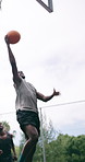 Men, basketball and team with goal or hoop for outdoor match, game or competition together. Male people, athlete or sport players in celebration with ball or net for winning, score or shoot on pitch
