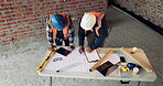 Talking, team or architect with blueprint at construction site, property layout or renovation project. Reading, above or people with maintenance idea for building plan, engineering or discussion