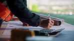 Hand, blueprint and architect at construction site for engineering, planning and math for infrastructure. Floor plan, calculator and man for renovation, property development and project management