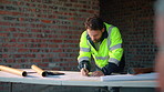 Man, engineer or writing at construction site for development, calculating measurements or review. Architect, calculator and blueprint on table for floor plan adjustment, accuracy and stock checklist