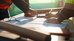 Blueprint, calculator and hands of people on construction site for budget review or update. Architecture, building and floor plan with team at table for development costs or expenses calculation