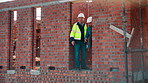 Engineer, team and discussion on construction site for planning, inspection or urban development. Men, inspector and pointing at worksite with building update, compliance checkup or quality assurance