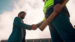 Manager, architect and handshake for teamwork at construction site, introduction or development deal. Below,  property project or people shake hands for agreement, renovation partnership and greeting
