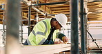 Construction worker, man and tape measure with wood for building, development and project. Tools, person and lumber at site for dimension accuracy, engineering or framework with architecture material