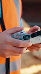 Architect, hands and drone controller at construction site, searching and infrastructure inspection. Architecture, survey and person with equipment for property development and civil engineering