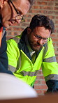 Men, meeting or construction planning with architect on site for project or building development. Male people, team or contractor with floor layout for civil engineering, security or structure safety