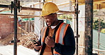 Fist pump, black man and construction worker on site with phone for bonus or infrastructure approval. Excited, cellphone and African male civil engineer with positive feedback on building project.