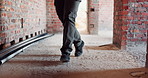 Construction, dance or legs on site with rhythm, energy or playful groove with project milestone. Achievement, man or engineer in building with fun time, feel good or upbeat movement in celebration.