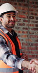 Construction, architect and shaking hands with man for partnership, deal or smile for collaboration. People, architecture or handshake for thank you, development agreement or success at building site
