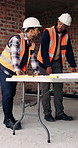 Construction, men and meeting with blueprint on site for design vision, building layout or update. Architect, team and talk with floor plan for structural inspection, safety and development progress