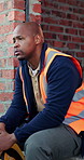 Thinking, tired or black man with helmet for construction, overwhelmed or renovation project pressure. Reflection, safety gear or worker with burnout for building workload, fatigue or remodel stress