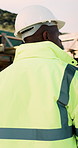 Construction, building and back of black man with reflection, inspiration and planning for property. Architecture, contractor and person with ppe for safety compliance, renovation ideas and thinking