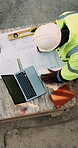 Blueprint, drawing and construction worker with laptop on site for planning home renovation from above. Floor plan, man and civil engineer with research for repairs, maintenance or building outdoor.