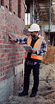 Construction, man and brick wall inspection with tablet for masonry, progress report or safety code. Tech, inspector and building assessment for structural integrity, verify brickwork and checklist