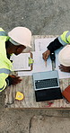 Blueprint, men and construction managers with laptop on site for planning home renovation from above. Floor plan, computer and male civil engineers in discussion for repairs, maintenance or building.