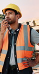 Construction, talking and man with radio at site for communication, feedback and update. Architecture, engineering and person with instructions for building progress, renovation and infrastructure