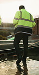 Construction, legs or team walk on site for building inspection, safety compliance or flare. Men, boots or back of foreman on rooftop for project management, quality assurance or development progress