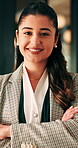 Arms crossed, face and smile of business woman in office for financial career or consulting. Corporate, friendly and thinking with happy broker in workplace for banking, finance or investment advice