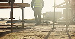 Legs, engineer and walking on rooftop for construction, inspection and planning for architecture. Back, man and thinking with hard hat for quality assurance, building progress and urban development