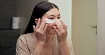 Mirror, skincare and asian woman with eye patches in bathroom for collagen treatment in home. Female person, beauty mask or cosmetics with facial for hydration, vitamin C or hyaluronic acid in house