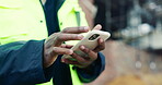 Hands, typing and phone on construction site with schedule, building app and research development. Person, engineer and mobile at worksite for assessment, review and online for renovation report
