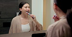 Mirror, cleaning and asian woman with toothbrush in bathroom for dental hygiene in home. Female person, oral care or brushing teeth with reflection for fresh breathe or morning routine in house