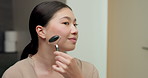 Skincare, massage or asian woman with jade roller in home for anti aging treatment or collagen. Female person, relax or facial with beauty tool for lymphatic drainage or circulation in bathroom